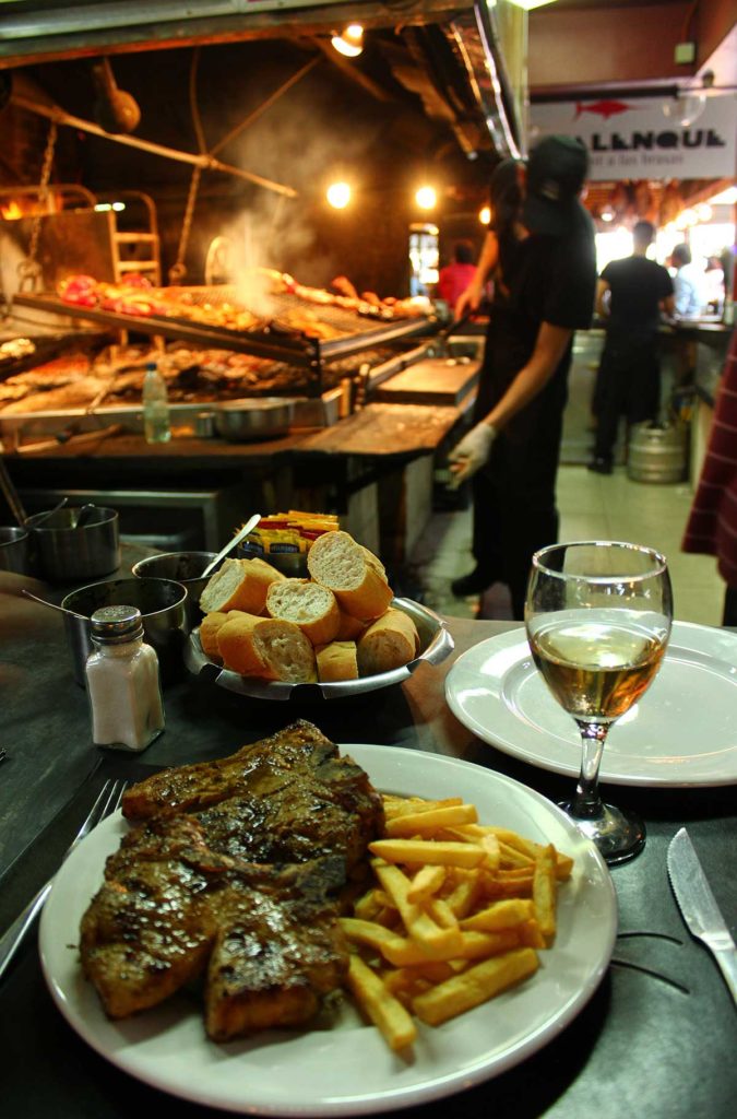 Parrilla é servida no balcão de restaurante do Mercado del Puerto, em Montevidéu (Uruguai)