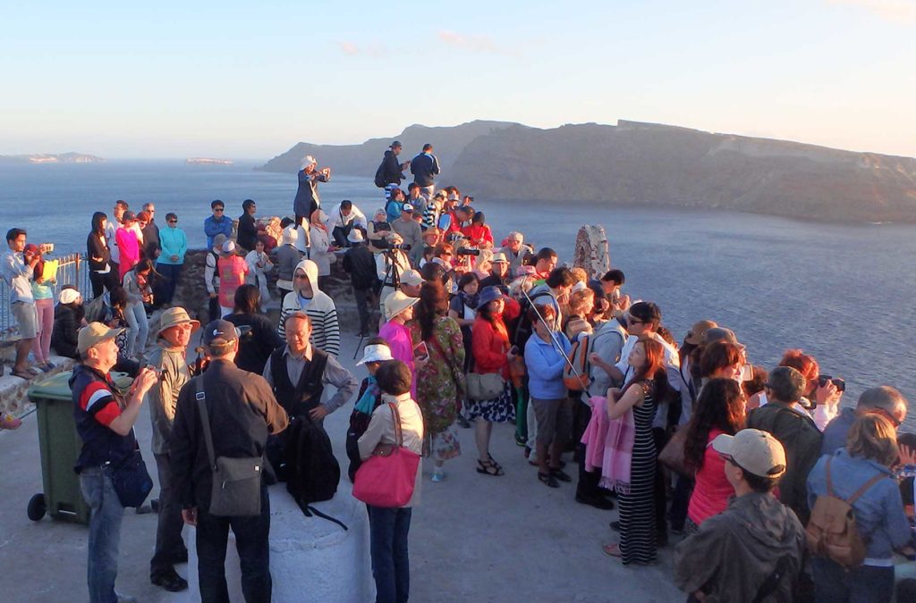Multidão se aglomera para ver o pôr do sol em Oía, na Ilha de Santorini (Grécia)