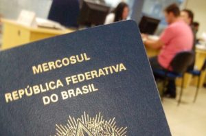 Pessoas com passaporte na mão são atendidas na Polícia Federal