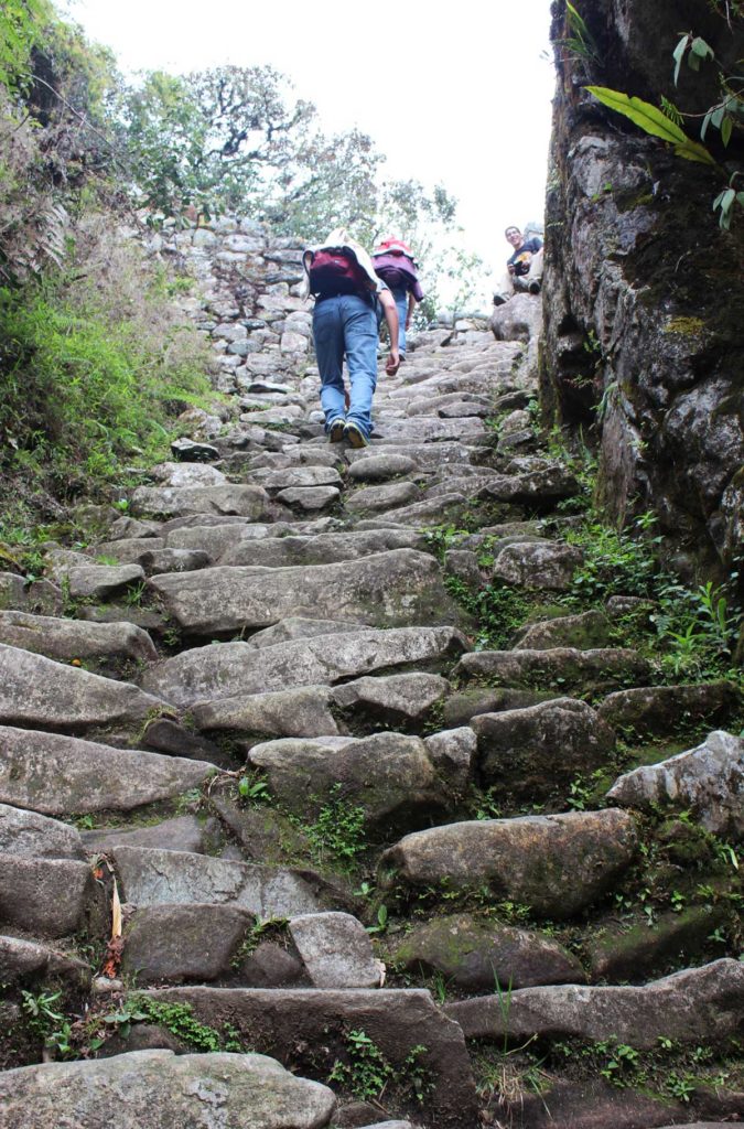 Turistas sobem escadaria de pedra que faz parte da Trilha Inca