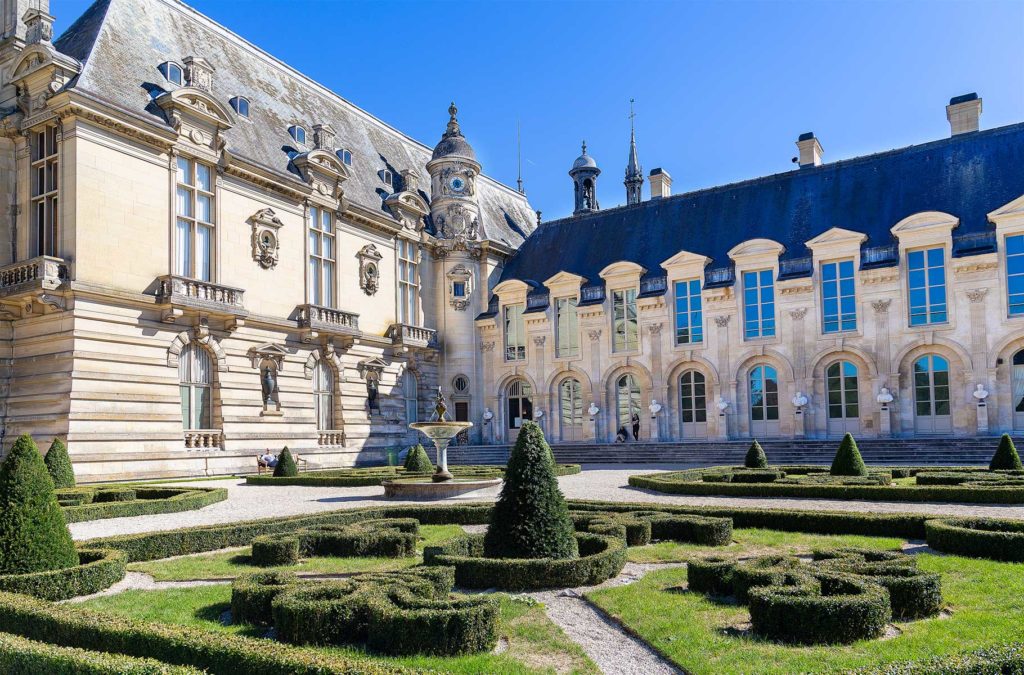 Jardim com o Castelo de Chantilly, na França, ao fundo