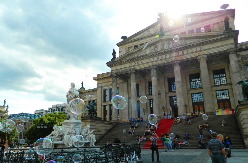 Pessoas brincam com bolhas de sabão na Gendarmenmarkt, uma das praças mais bonitas de Berlim