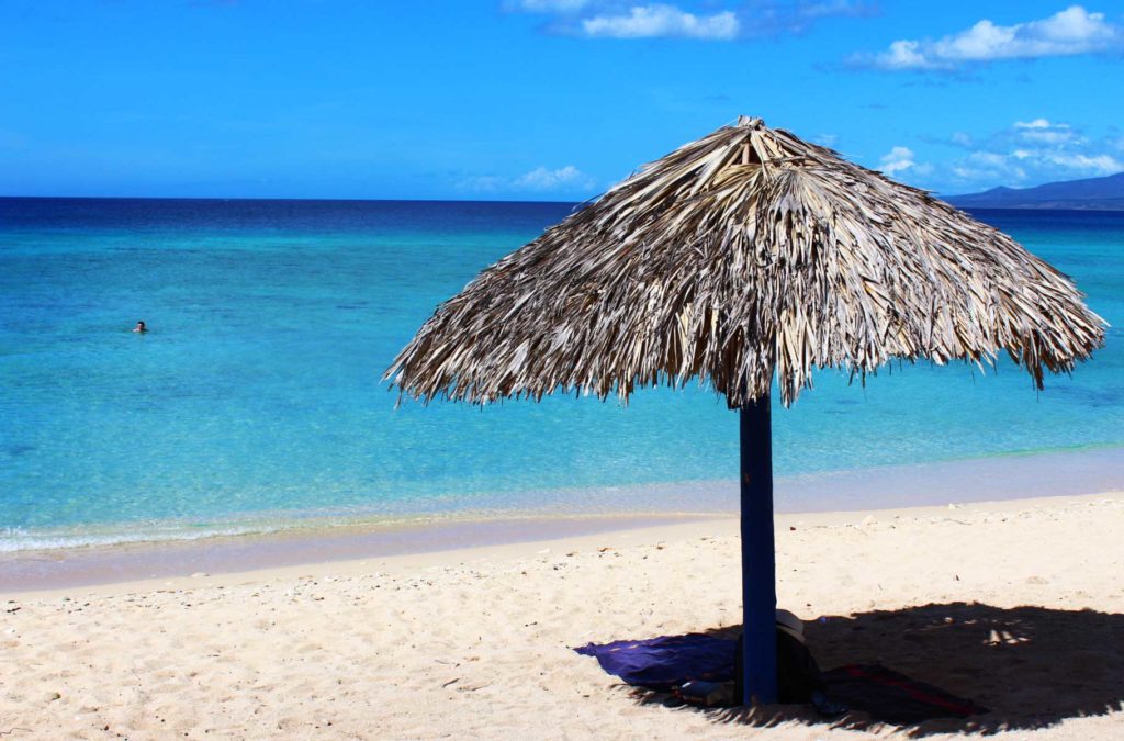 Palapa fornece sombra em praia de Trinidad, em Cuba